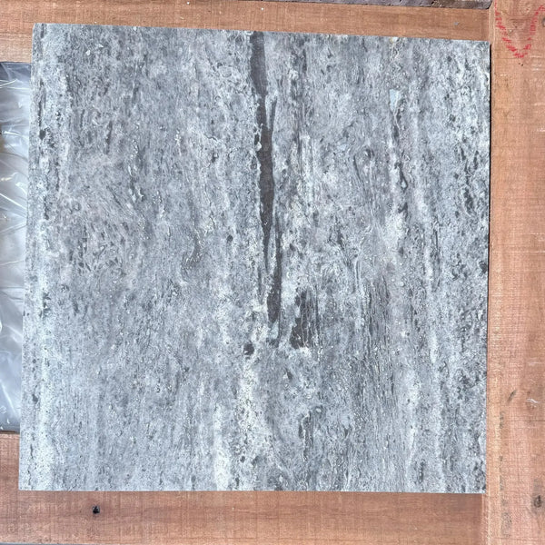Gray marble tile with dark veining in Silver Travertine 12X12 Filled and Honed
