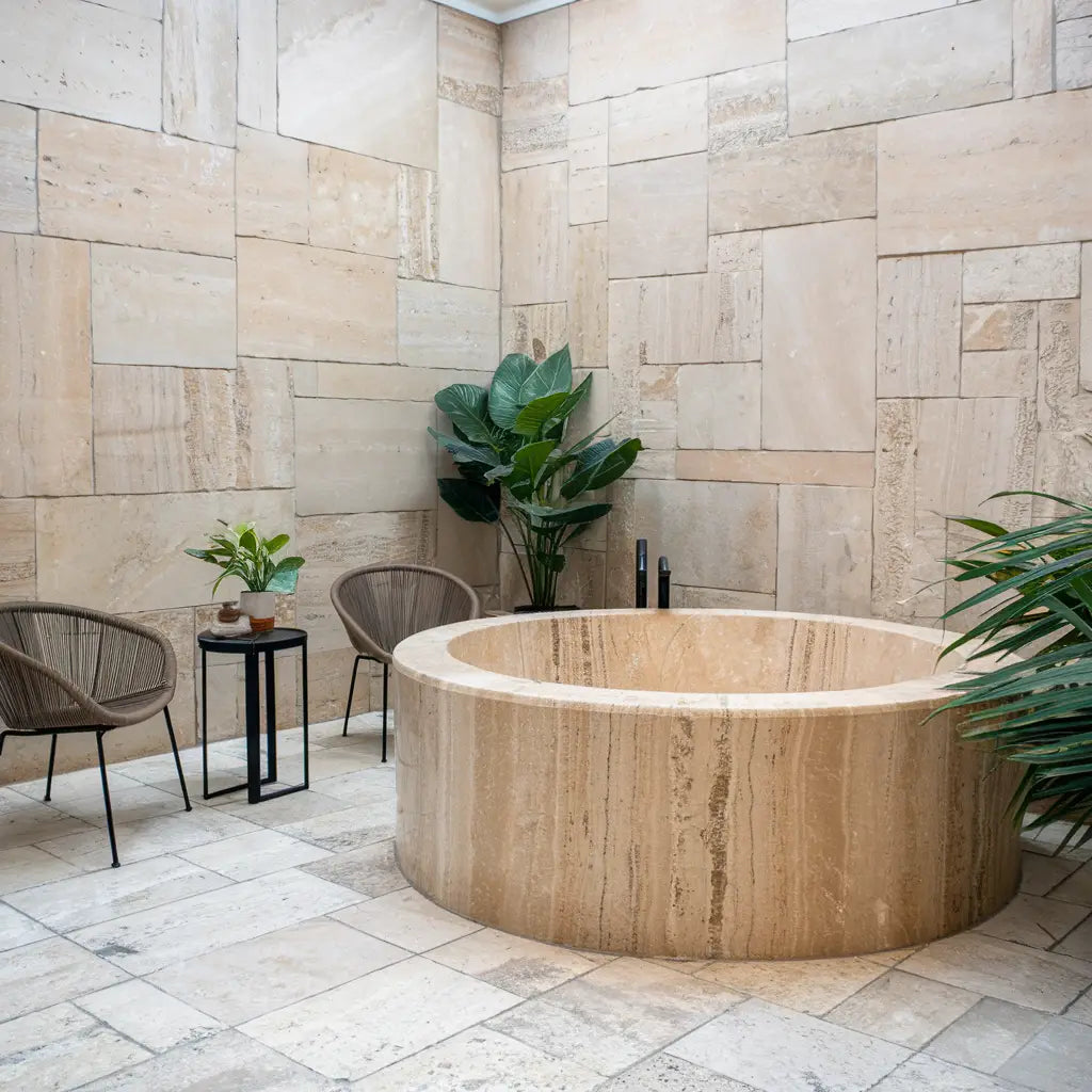 Round stone bathtub featuring Travertine Tiles for elegant bathroom design