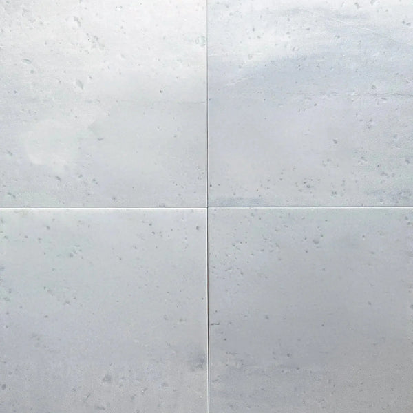 Four polished Aegean White Marble tiles displayed in a product listing