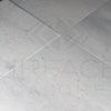 White speckled Agean White Marble 12X12 Polished Tile in a stylish flooring display
