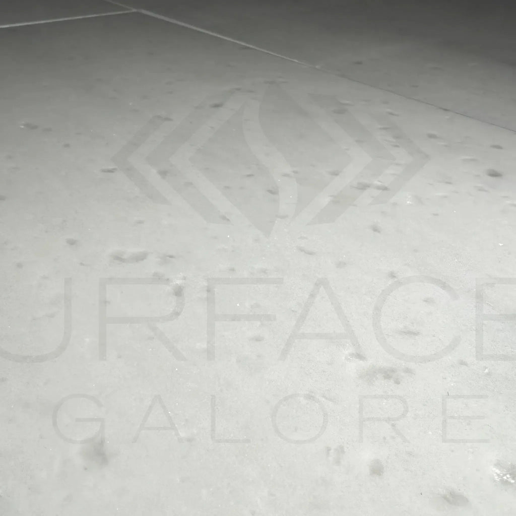 Etched logo on Agean White Marble 18X18 Polished Tile showcasing elegance and quality
