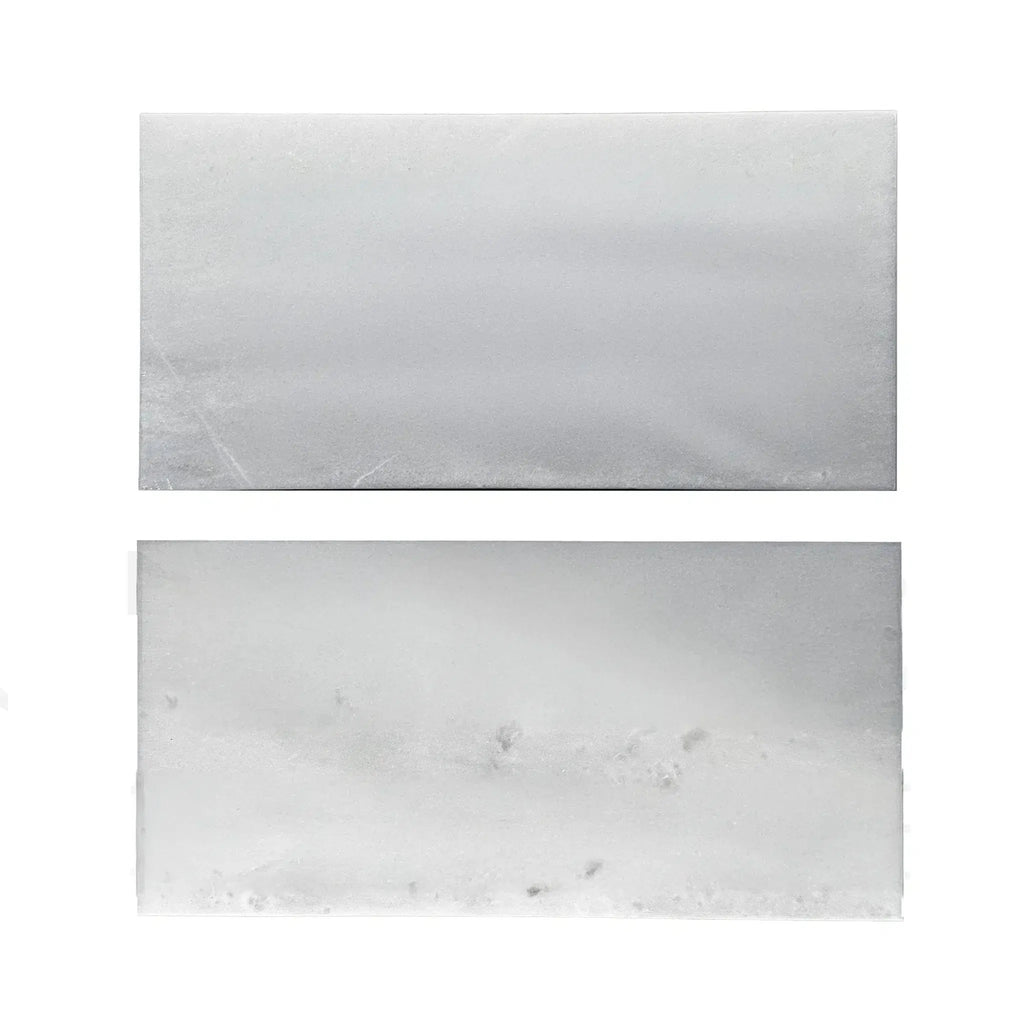 Two rectangular blocks of white wax beside Agean White Polished Tile samples
