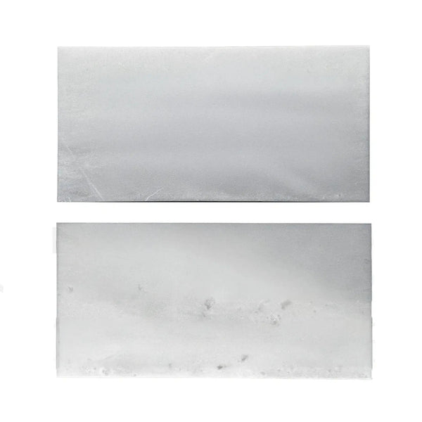 Two rectangular blocks of white wax beside Agean White Polished Tile samples