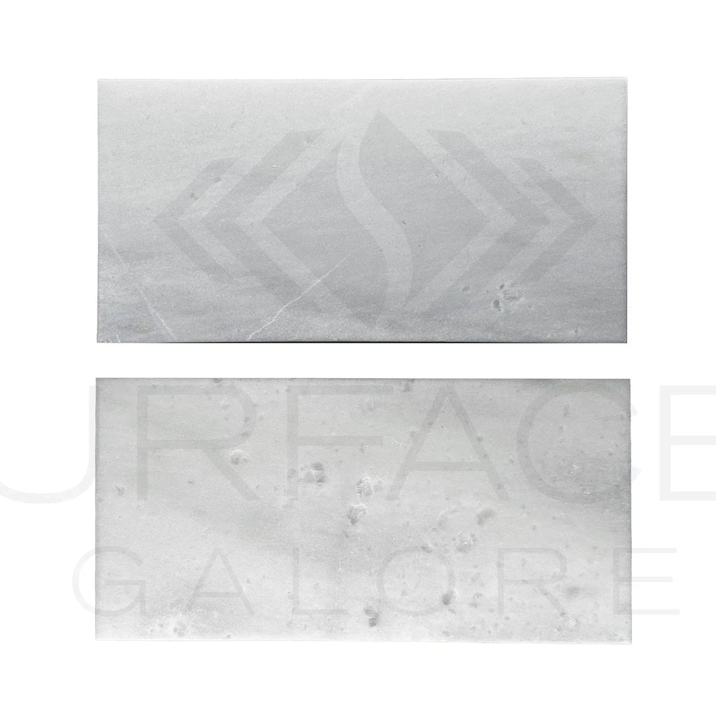 Two rectangular bars of soap displayed with Agean White Snow White Marble Tile