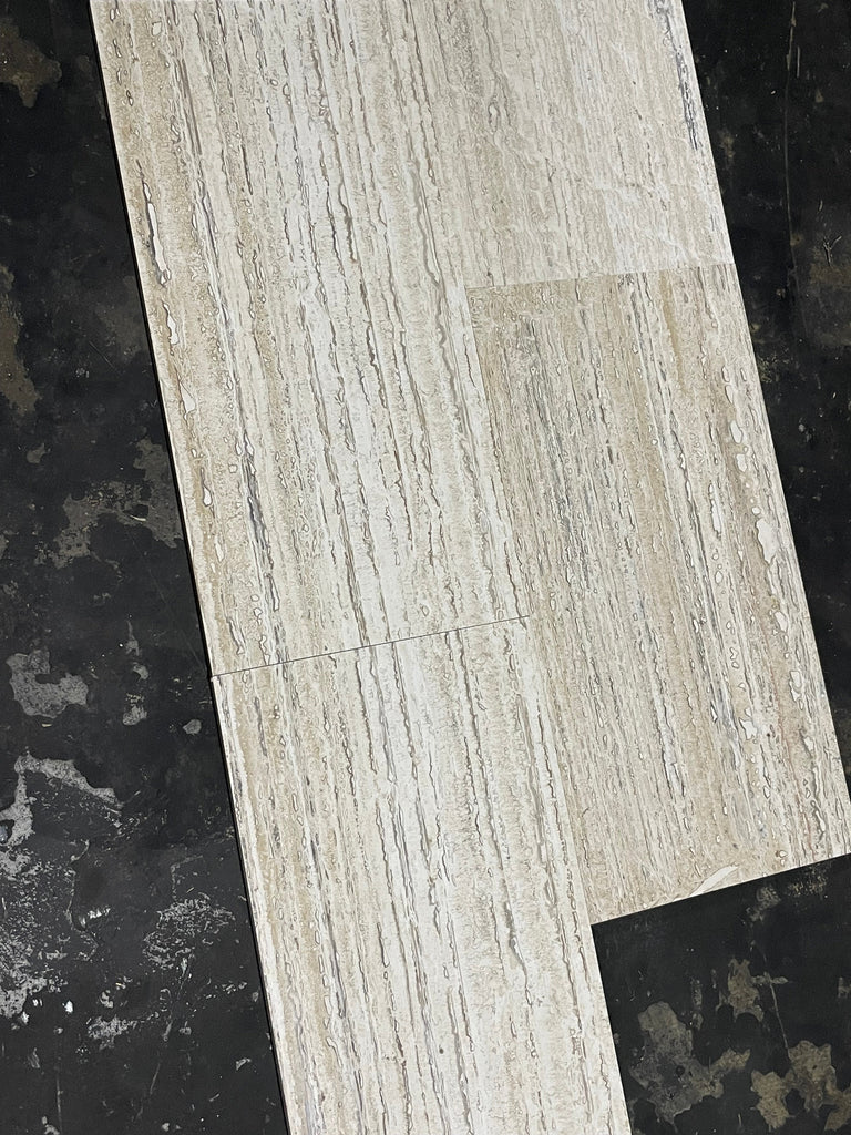 Light gray stone-effect vinyl plank with Alabastrino Rustic White travertine grain