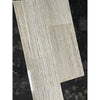 Light gray wood-grain vinyl plank flooring with glossy finish
