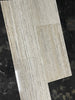 Light gray wood-grain vinyl plank flooring with glossy finish