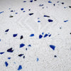 White Andromeda Quartz countertop with blue and black flecks in polished tile format