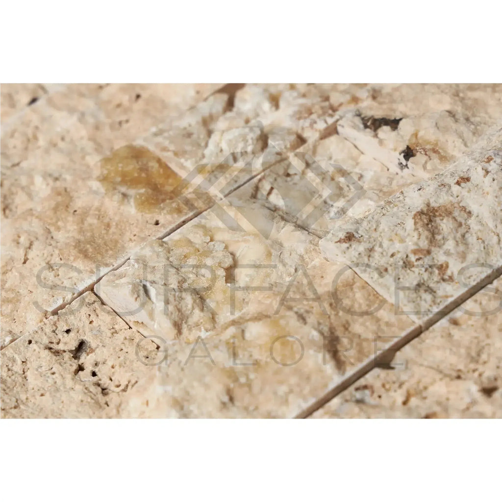 Textured beige stone tiles of Antico Onyx Travertine 2X4 Brick Mosaic Split-Faced