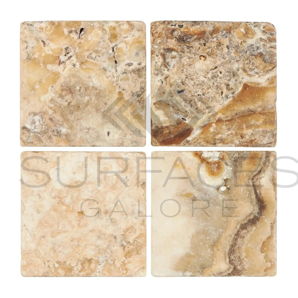 Four Antico Onyx Travertine 6X6 Tumbled tiles showcasing natural stone texture