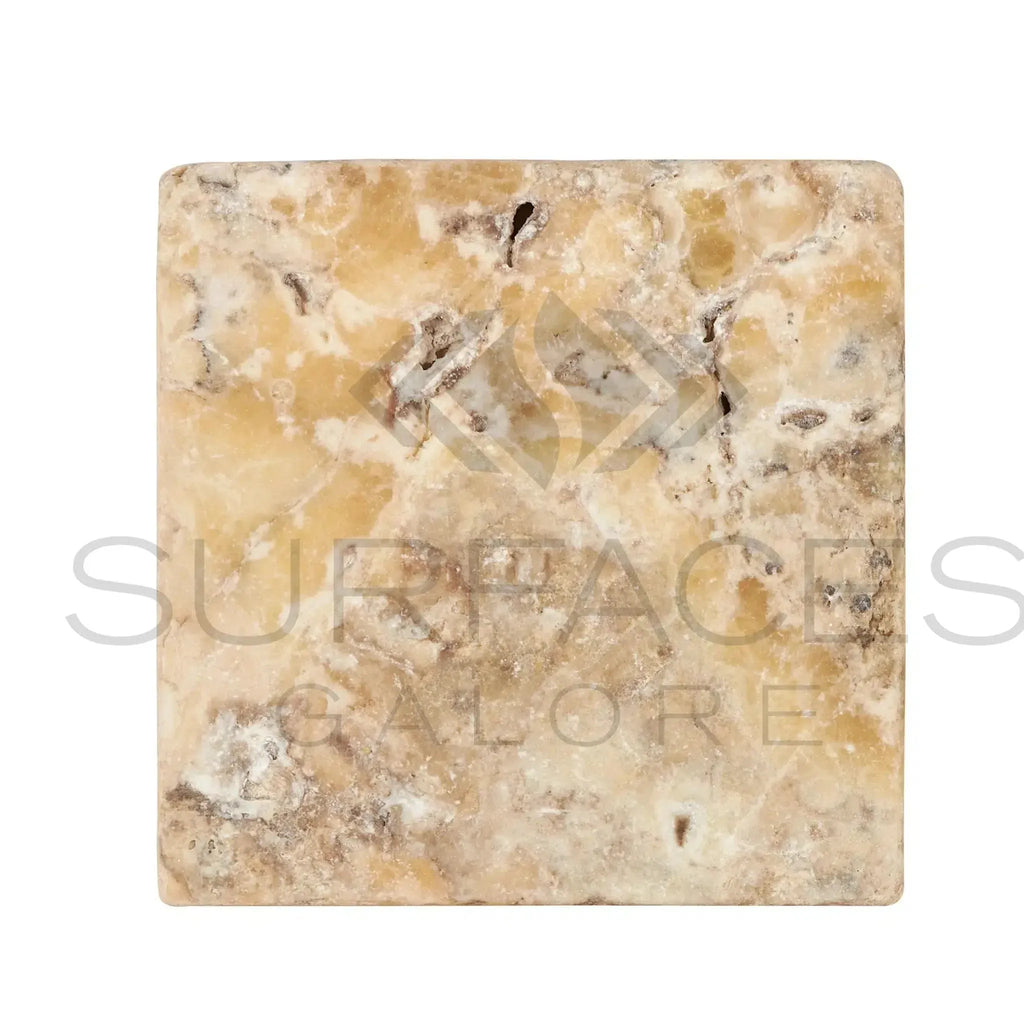 Square marble tile featuring beige and brown veining in Antico Onyx Travertine 6X6 Tumbled