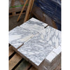 Multiple square Arabescato Corchia marble tiles with prominent gray veining
