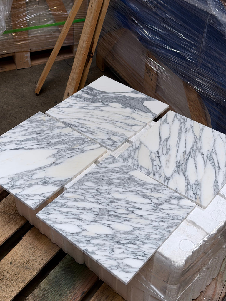 Multiple square Arabescato Corchia marble tiles with prominent gray veining