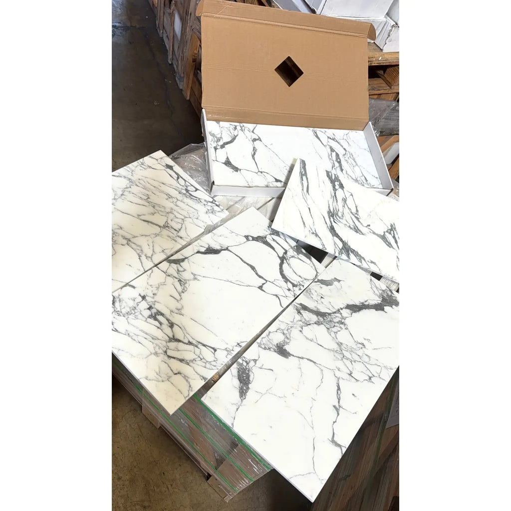 White marble effect arabescato corchia 12x24 polished or honed tiles with intricate gray veining stacked in boxes