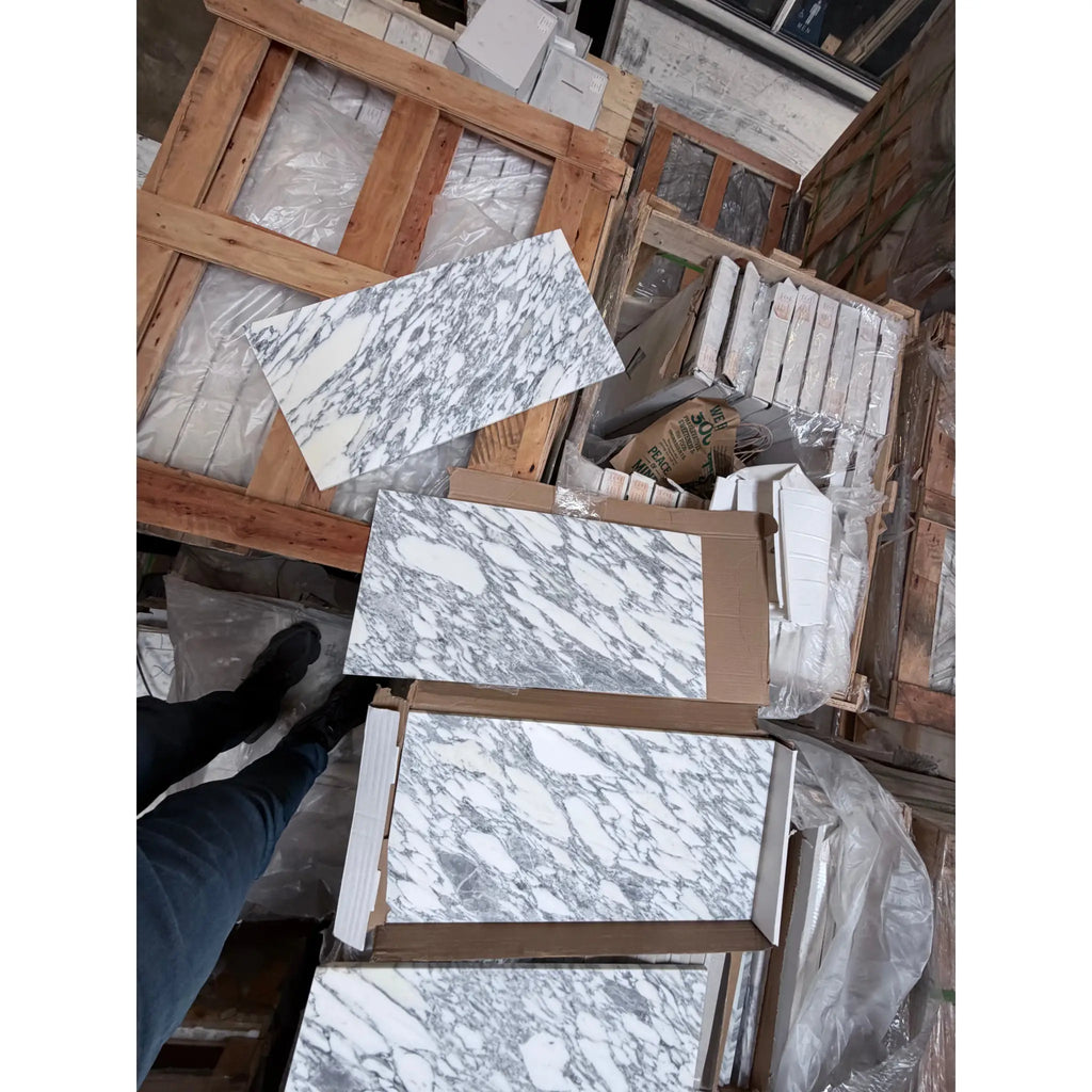 Arabescato Corchia 12x24 polished marble tile slabs in white gray veined pattern on pallets