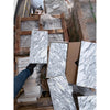 Stacked white and gray veined Arabescato Corchia marble slabs on pallets