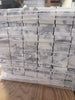 Stack of Arabescato Corchia white gray marble mosaic tiles in plastic