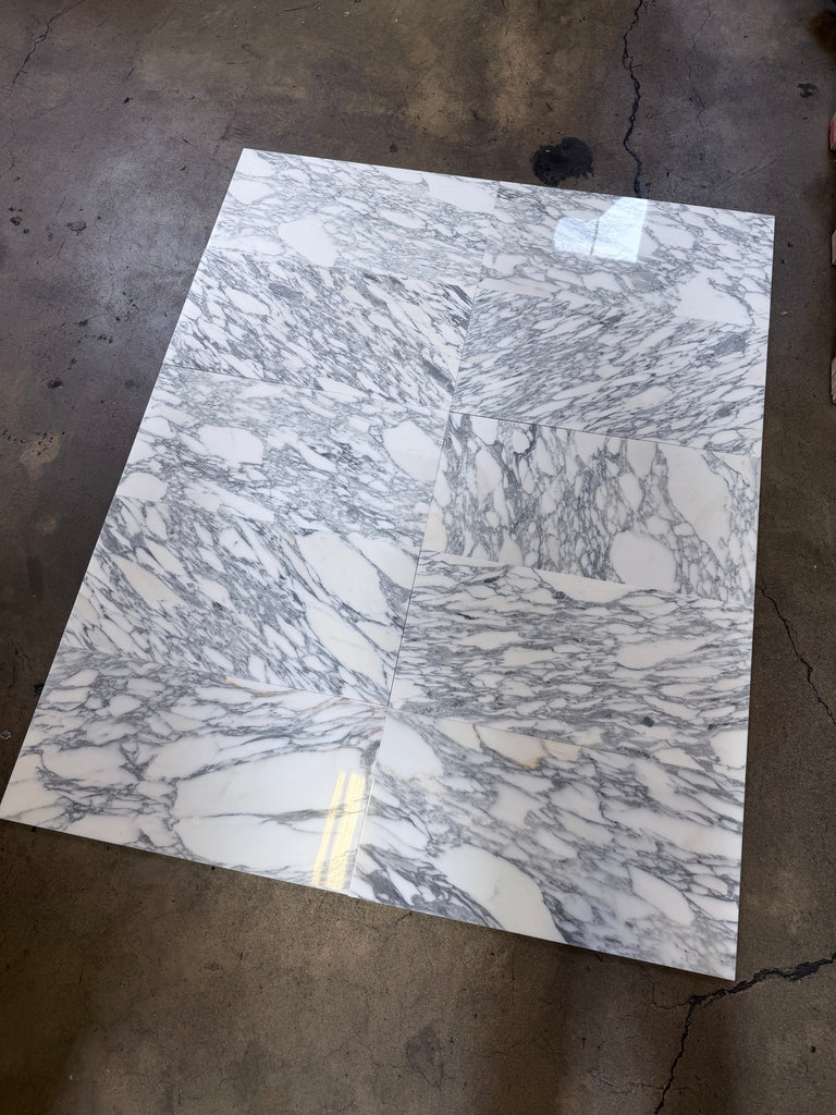 Polished Arabescato Corchia 12x24 marble tile with white base, gray veining, gold accents