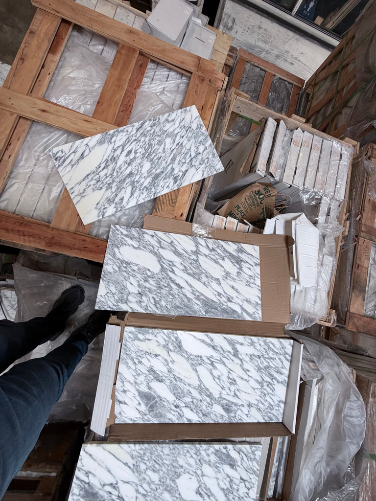 Arabescato Corchia 12x24 polished marble tile slabs in white gray veined pattern on pallets