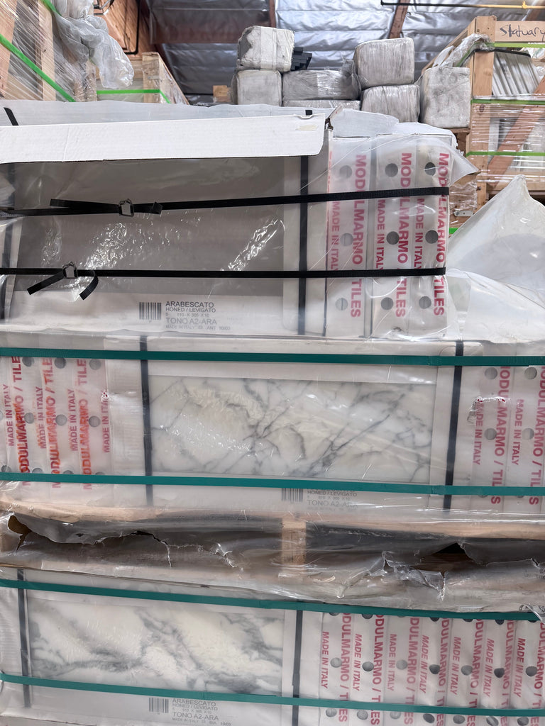 Polished Arabescato Corchia 12x24 marble tile with white base, gray veining, in clear plastic packaging secured by black straps