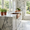 White marble countertop with gray veining and copper sink featuring arabescato corchia 18x18 polished marble tile