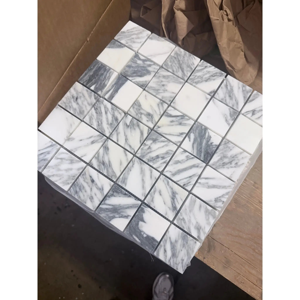 White and gray Arabescato Corchia 2x2 marble mosaic tiles with swirling pattern