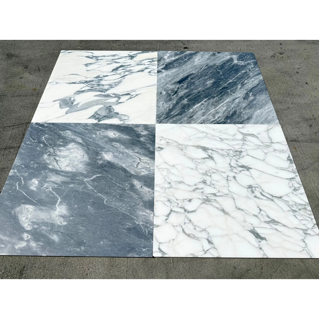 Four marble tile samples featuring Arabescato Corchia with white and grey veining