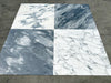 Four marble tile samples featuring Arabescato Corchia with white and grey veining