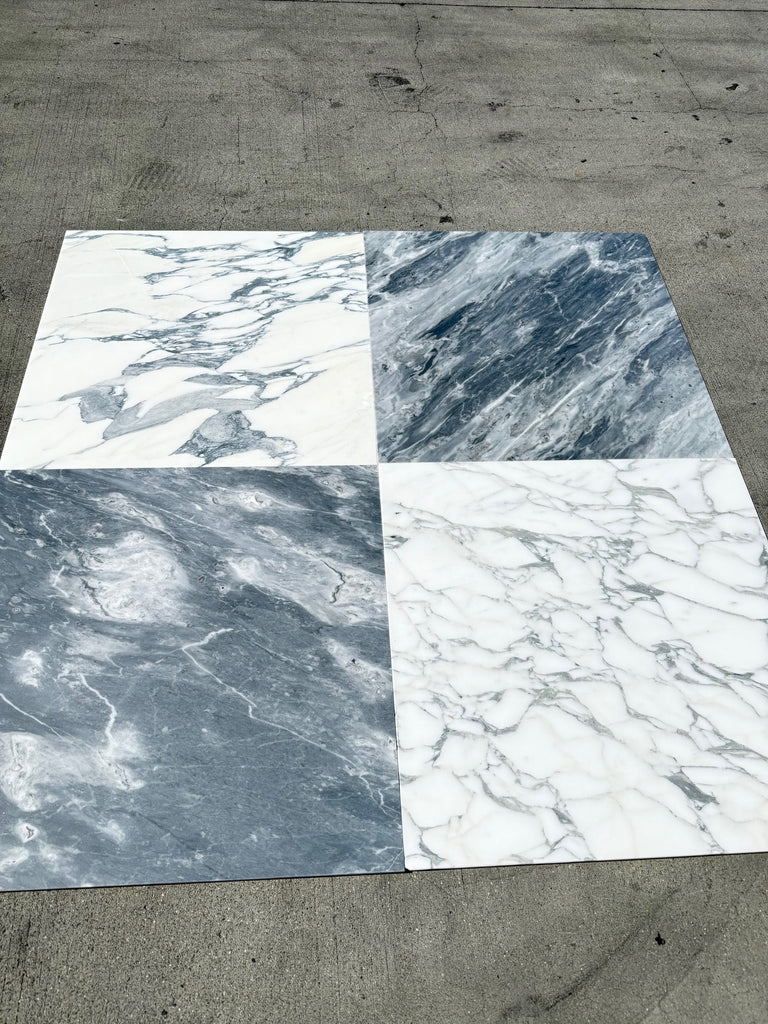 Four marble-effect tile samples in white and grey for Arabescato Corchia 24x24 marble tile