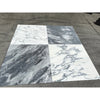 Four large Arabescato Corchia 24x24 marble tiles in subtle white veining and dramatic dark gray streaks