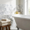 White clawfoot bathtub with classic curved design and ornate silver-colored feet in arabescato corchia 2x2 polished or honed