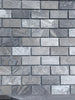 Gray marble-effect brick mosaic tile wall in Atlantic Gray Marble 1x2 polished or honed