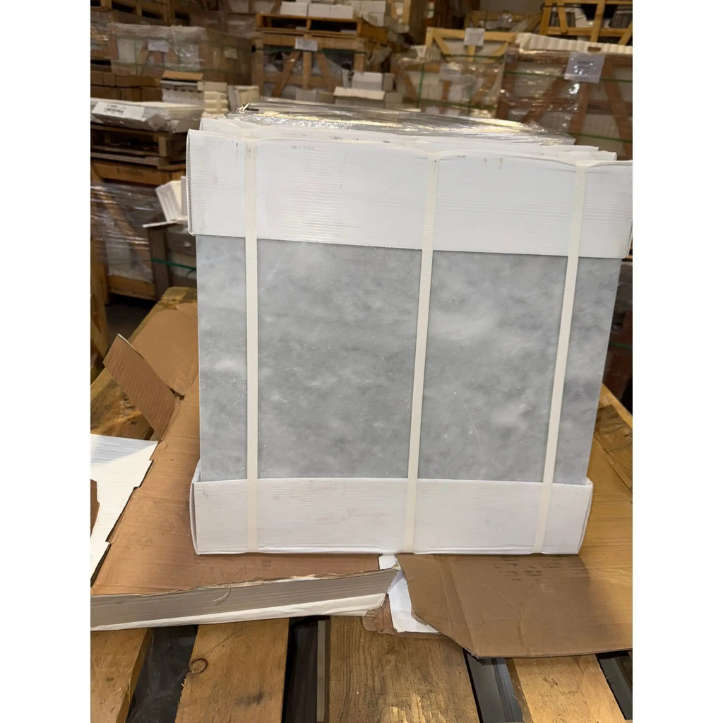 Stack of gray Azure Imperio 12x12 marble tiles in white packaging
