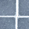 Four dark grey Bardiglio 3x3 Tumbled square tiles with visible white grout lines