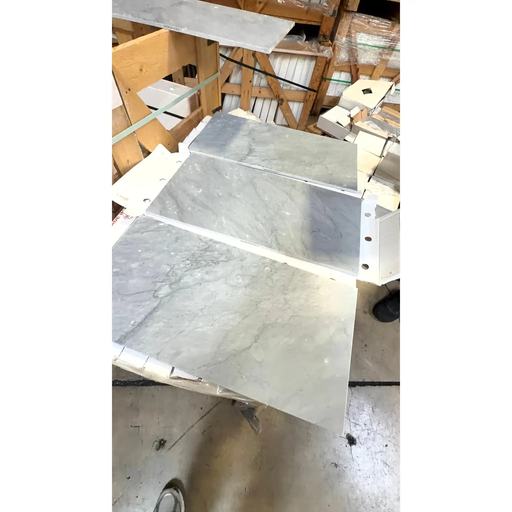Bardiglio Imperiale 12x24 polished or honed gray marble tiles with subtle veining stacked in white protective packaging