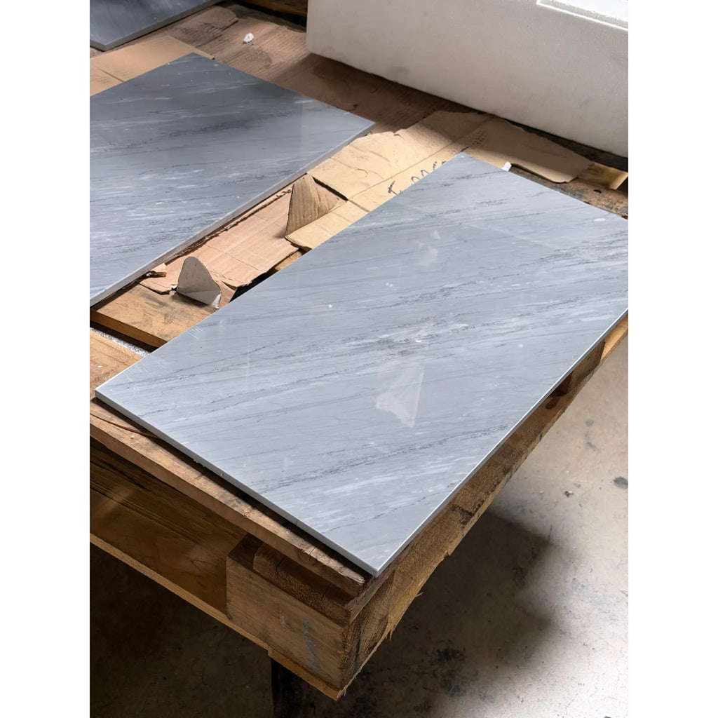 Bardiglio imperiale 12x24 gray marble-effect tile with subtle veining and a glossy polished finish