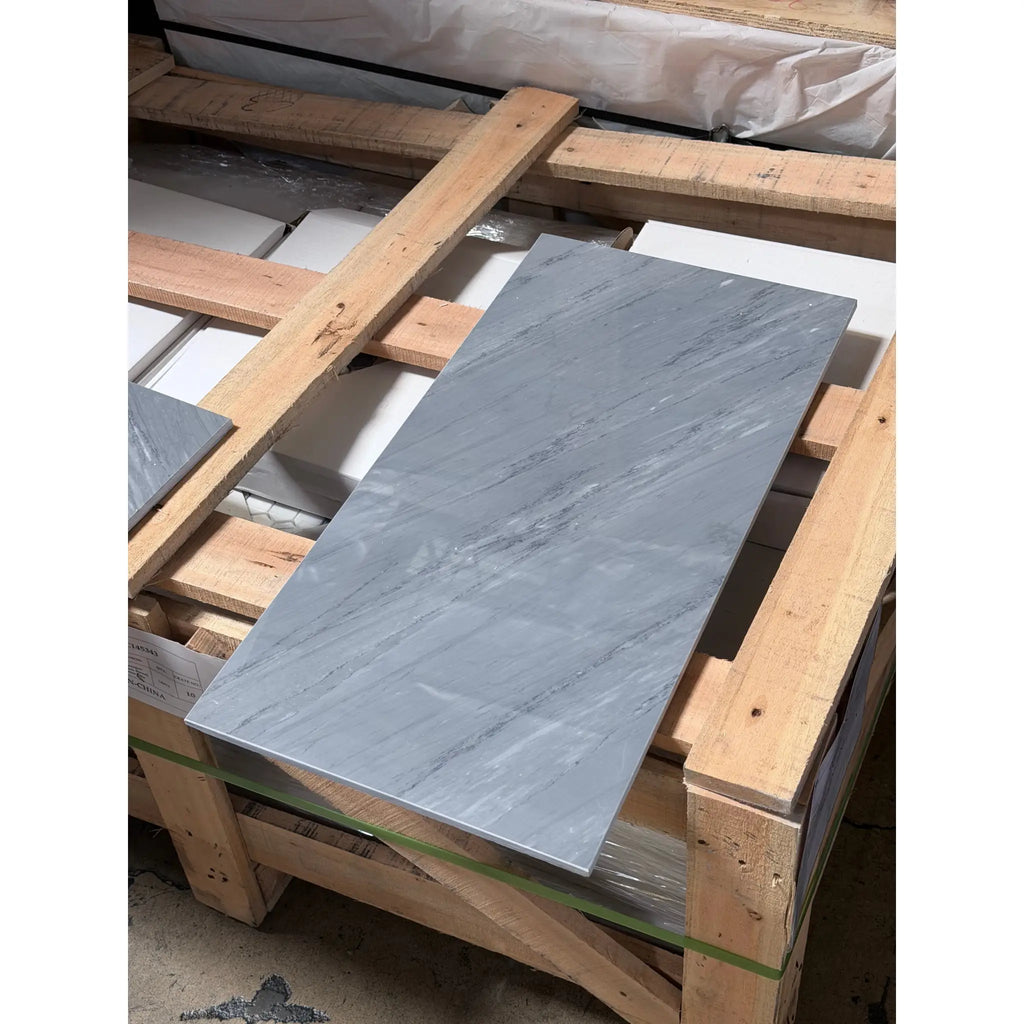 Bardiglio Imperiale 12x24 gray marble tile with subtle white veining resting on a wooden pallet polished or honed finish