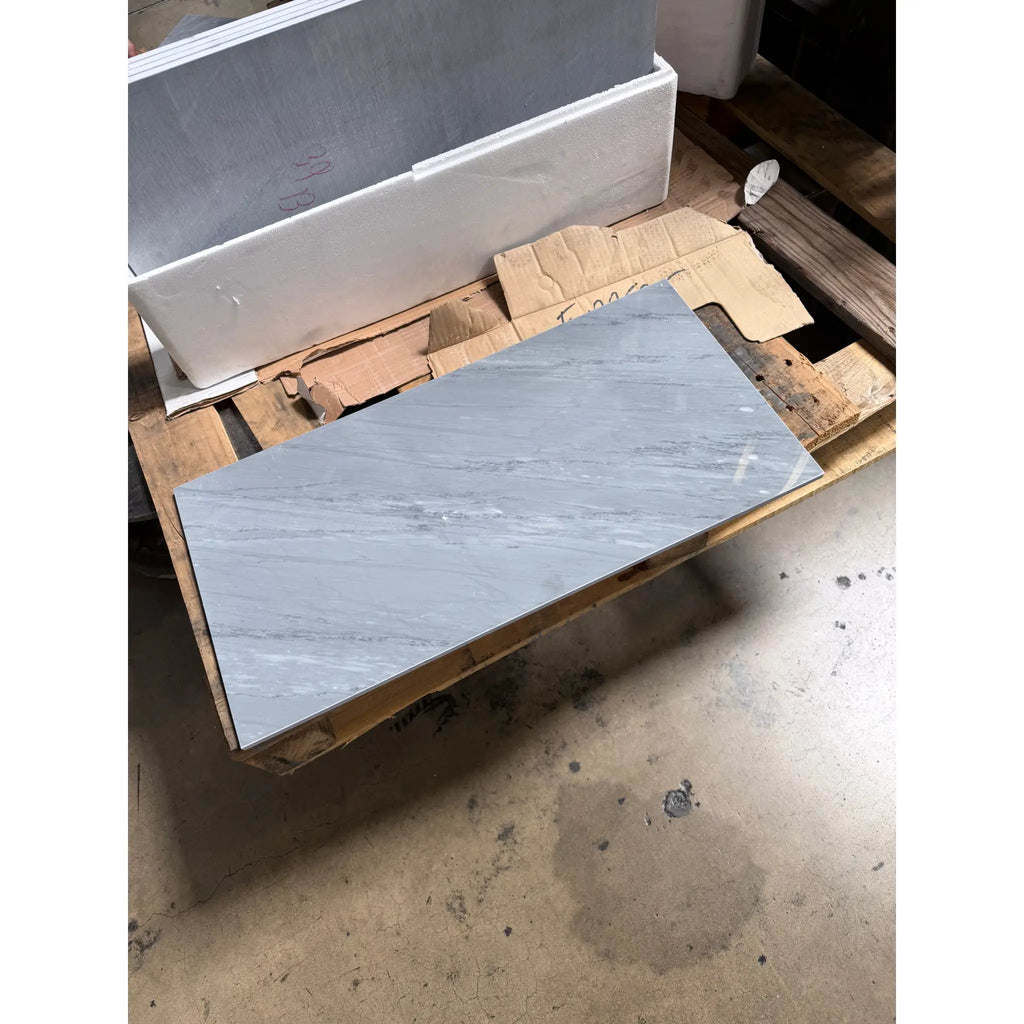 Bardiglio imperiale 12x24 gray marble tile with subtle white veining polished or honed resting on a wooden pallet