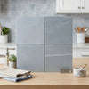 Light gray bardiglio imperiale 18x18 marble polished or honed ceramic tiles with subtle veining arranged in a 2x2 display