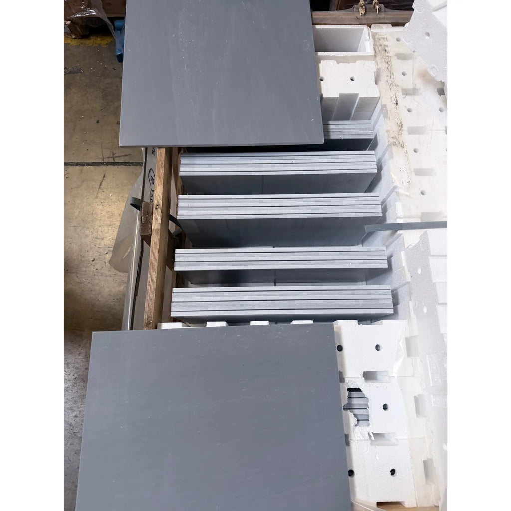 Stacks of Bardiglio Imperiale 18x18 polished marble panels