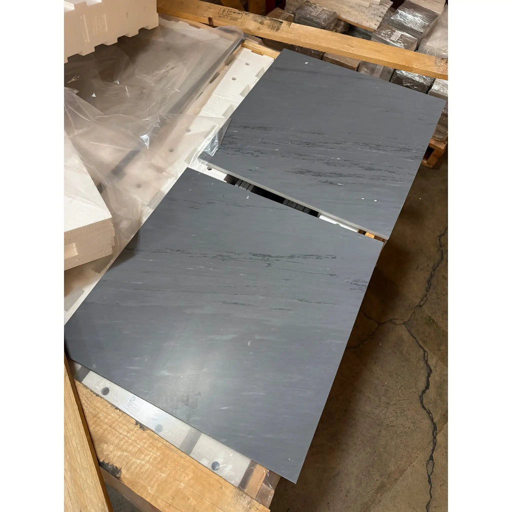 Two dark gray Bardiglio Imperiale 18x18 marble slabs on pallet