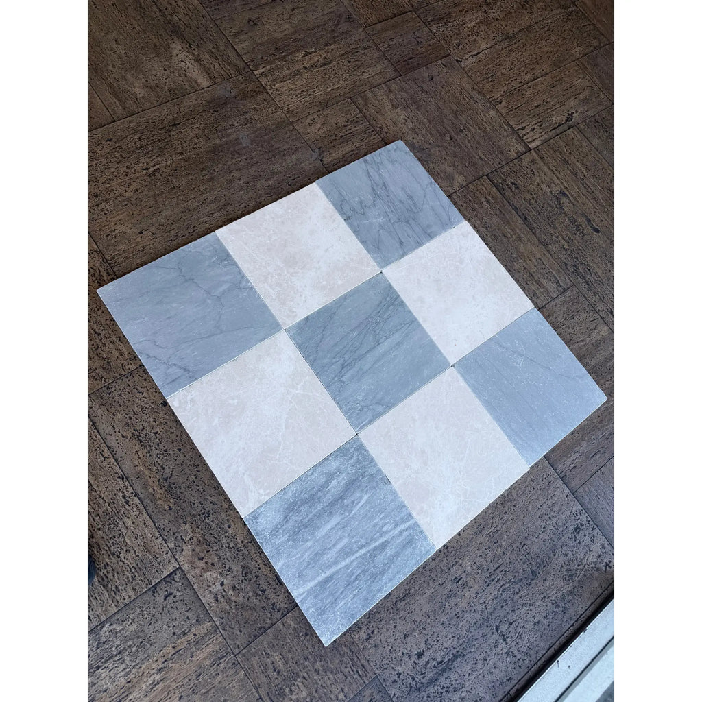 A square bardiglio imperiale 12x12 marble tumbled mosaic tile mat with a checkerboard pattern of light gray and white tiles