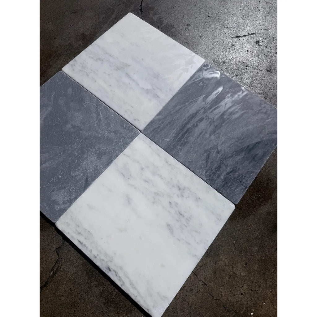 Four square bardiglio imperiale 12x12 marble tumbled tiles in white and dark gray with natural veining patterns