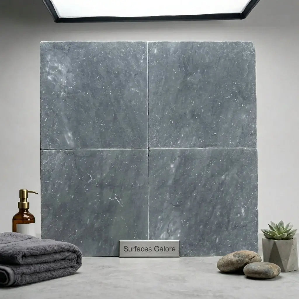 Four square 12x12 bardiglio imperiale gray marble tiles with tumbled finish arranged in a grid pattern