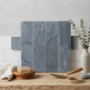 Bardiglio imperiale marble 3 x 12 field tile with blue gray subway tiles featuring subtle veining arranged vertically