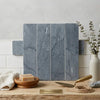 Set of four vertical bardiglio imperiale marble 3 x 12 inch field tiles in gray with subtle white veining arranged as sample display