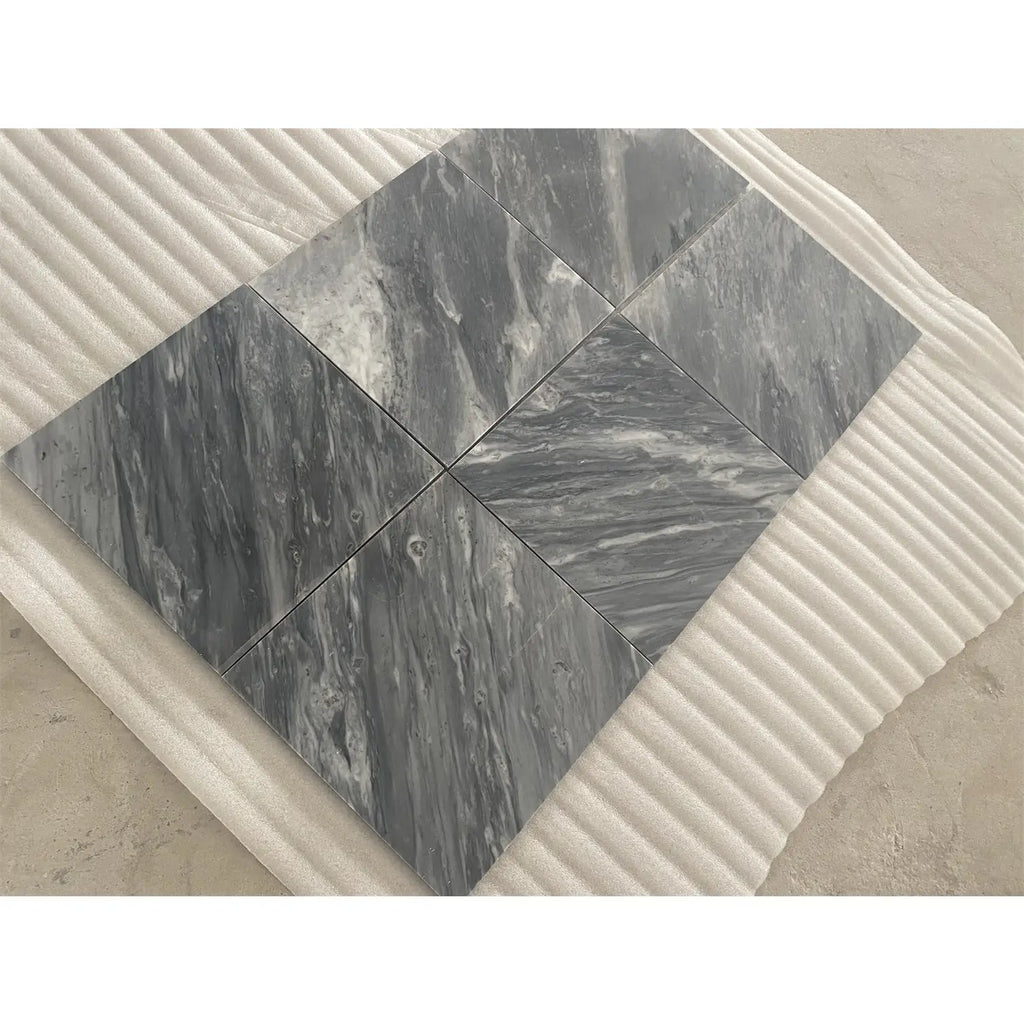 Gray marble tiles bardiglio nuvolato 12x12 polished with swirling white veining arranged in a diamond pattern