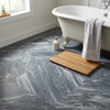 A rectangular wooden bath mat with parallel slats and natural light brown finish displayed alongside bardiglio nuvolato 24x24 marble polished or honed tiles