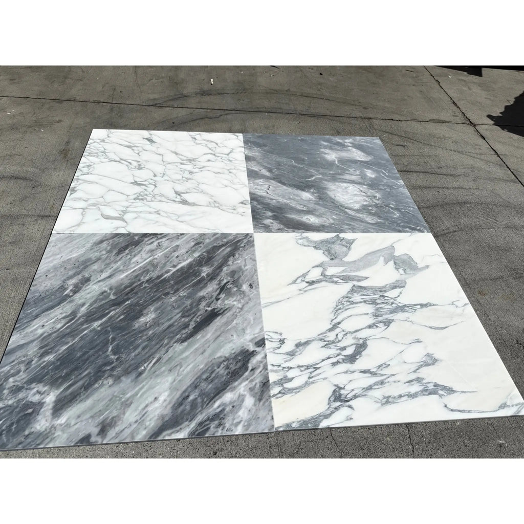 Four large marble tiles in white and gray with veining, arranged in a checkerboard pattern