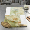 A rectangular slab of fine Italian onyx marble in pale green with creamy white and golden veining from Bari set